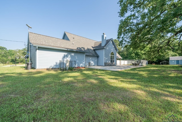 back of property featuring a lawn and a patio