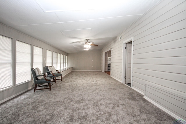 unfurnished sunroom featuring carpet flooring