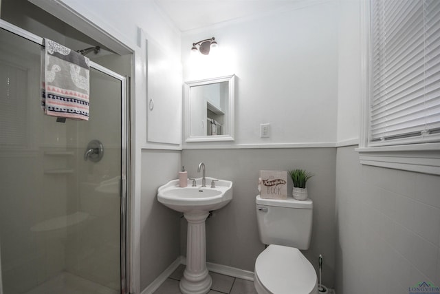 bathroom featuring a shower stall, tile patterned flooring, tile walls, and toilet