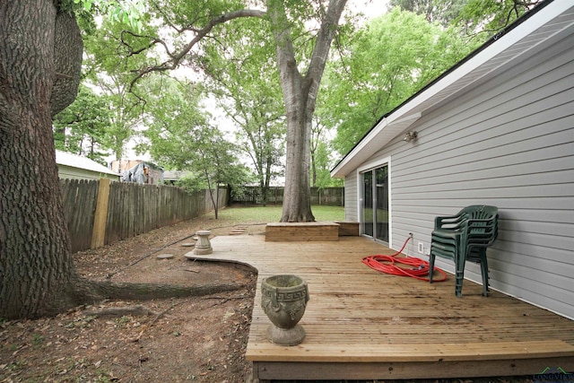 wooden terrace featuring a fenced backyard