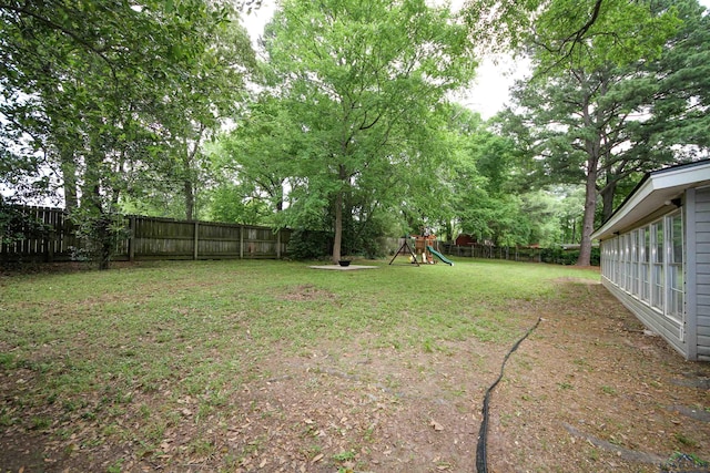 view of yard featuring a fenced backyard and a playground