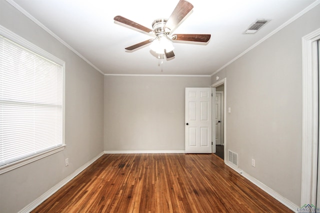 spare room with visible vents, ceiling fan, wood finished floors, and baseboards