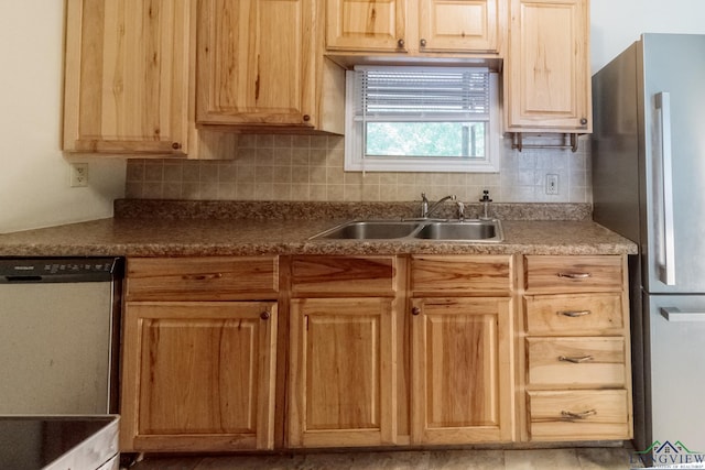 kitchen with a sink, light brown cabinets, freestanding refrigerator, tasteful backsplash, and dishwashing machine