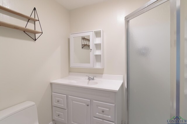 1321 Lake Dr, Longview, TX 75601 - full bathroom featuring vanity, toilet, and a shower stall