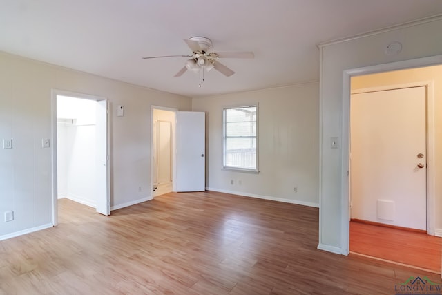 1321 Lake Dr, Longview, TX 75601 - unfurnished living room with ceiling fan, baseboards, and light wood-style flooring