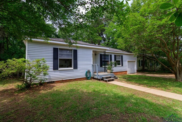 view of front of property with an attached garage, a front lawn, driveway, and crawl space