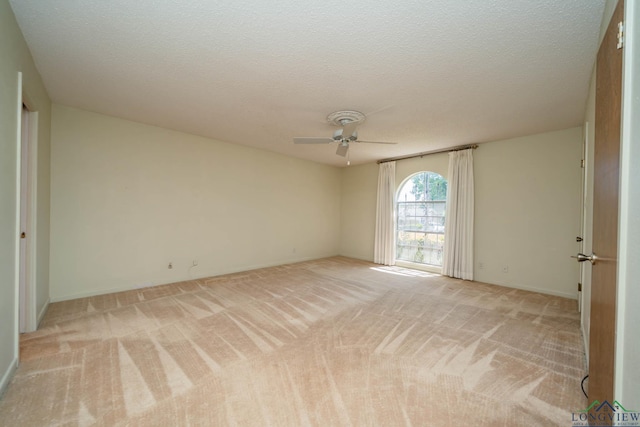 107 Tulip St, White Oak, TX 75693 - empty room featuring light colored carpet, ceiling fan, and baseboards