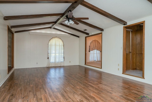 107 Tulip St, White Oak, TX 75693 - empty room featuring wood finished floors, ceiling fan, wooden walls, and vaulted ceiling with beams