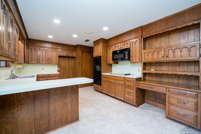 107 Tulip St, White Oak, TX 75693 - kitchen with a sink, light countertops, black appliances, and built in desk