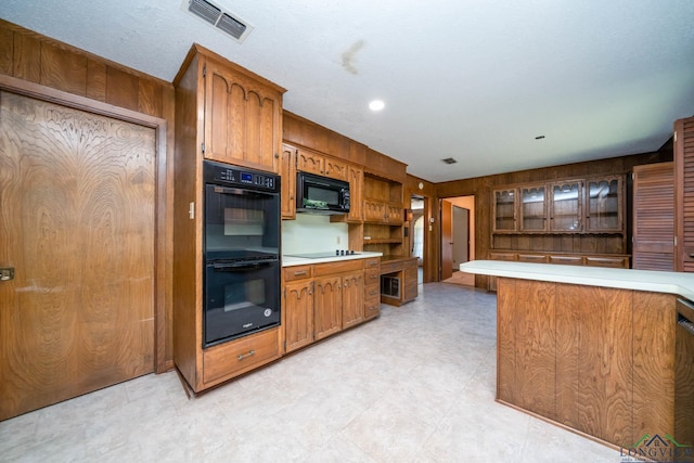 107 Tulip St, White Oak, TX 75693 - kitchen with brown cabinets, visible vents, light countertops, and black appliances