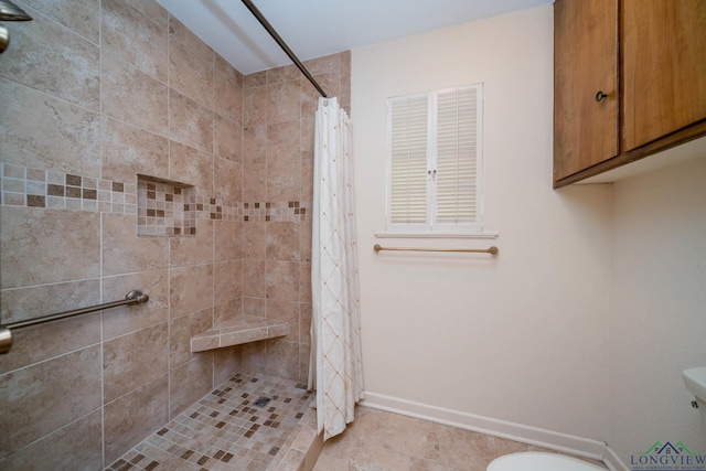 107 Tulip St, White Oak, TX 75693 - bathroom with toilet, tiled shower, and baseboards