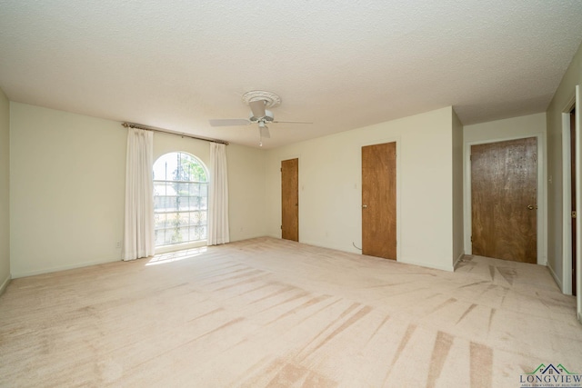 107 Tulip St, White Oak, TX 75693 - spare room featuring light carpet, ceiling fan, and a textured ceiling