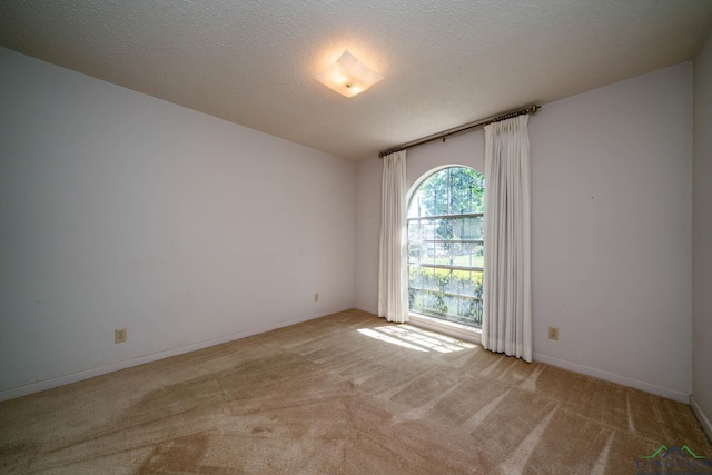 107 Tulip St, White Oak, TX 75693 - carpeted empty room with a textured ceiling and baseboards