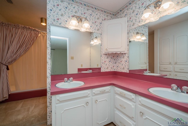 107 Tulip St, White Oak, TX 75693 - bathroom with a sink, double vanity, a shower with curtain, and wallpapered walls