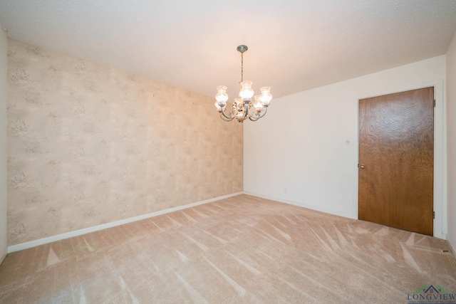 107 Tulip St, White Oak, TX 75693 - spare room with a chandelier, light carpet, baseboards, and wallpapered walls