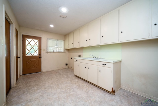 107 Tulip St, White Oak, TX 75693 - laundry room with washer hookup, a sink, cabinet space, electric dryer hookup, and light floors