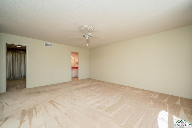 107 Tulip St, White Oak, TX 75693 - spare room featuring visible vents, ceiling fan, and light colored carpet