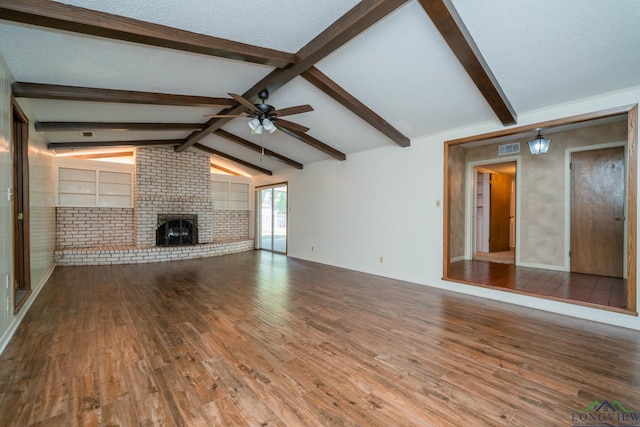 107 Tulip St, White Oak, TX 75693 - unfurnished living room with visible vents, ceiling fan, vaulted ceiling with beams, and wood finished floors