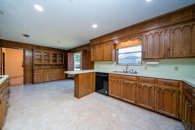 107 Tulip St, White Oak, TX 75693 - kitchen featuring a sink, wood walls, a peninsula, and dishwasher