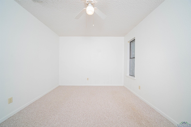 empty room featuring carpet flooring, ceiling fan, and a textured ceiling