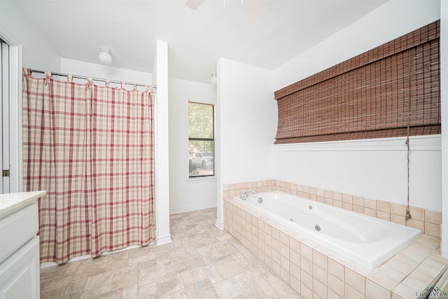 bathroom with a relaxing tiled tub and vanity