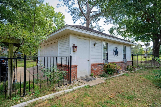 ranch-style house with a garage, an outdoor structure, and a front lawn