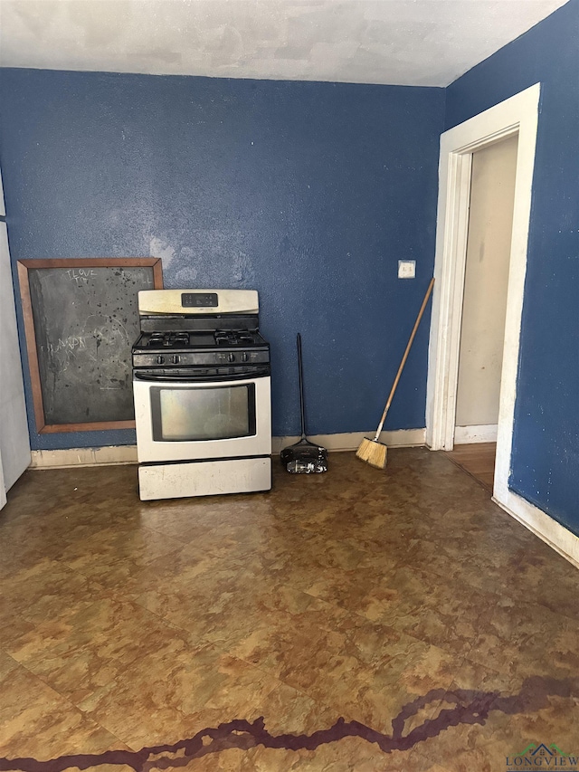 1701S Washington St, Marshall, TX 75670 - kitchen featuring stainless steel gas range and tile patterned floors