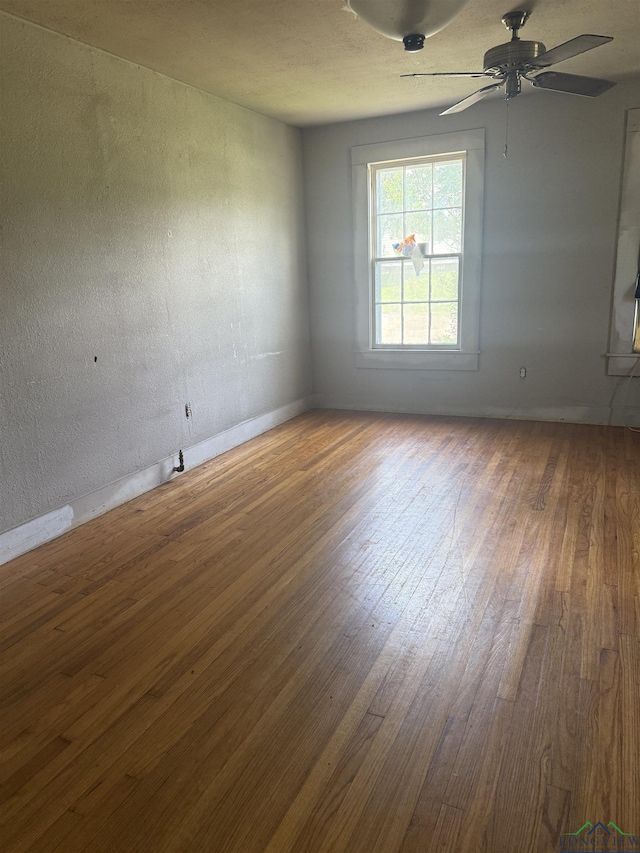 1701S Washington St, Marshall, TX 75670 - empty room with wood finished floors and ceiling fan