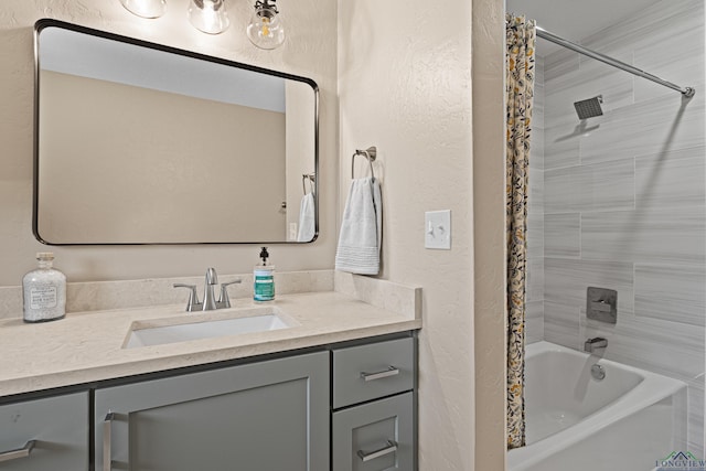 full bath with bathtub / shower combination, a textured wall, and vanity