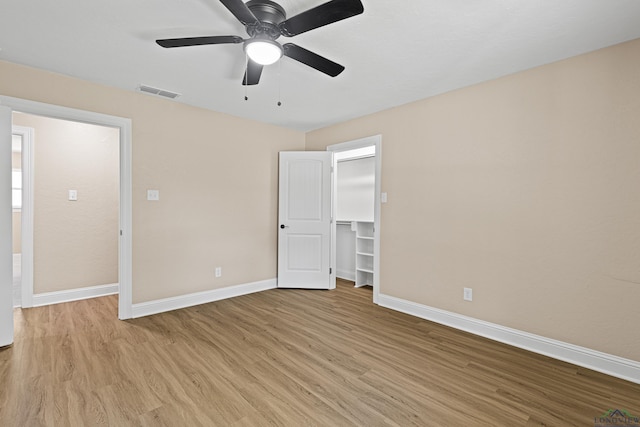 unfurnished bedroom with visible vents, ceiling fan, light wood-style flooring, and baseboards