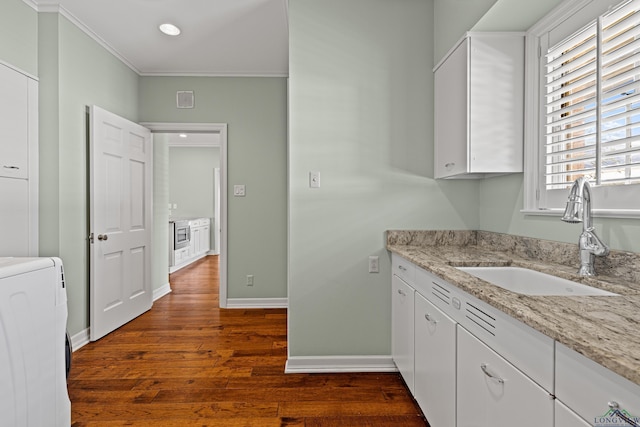 interior space with sink, white cabinetry, dark hardwood / wood-style floors, light stone counters, and washer / clothes dryer