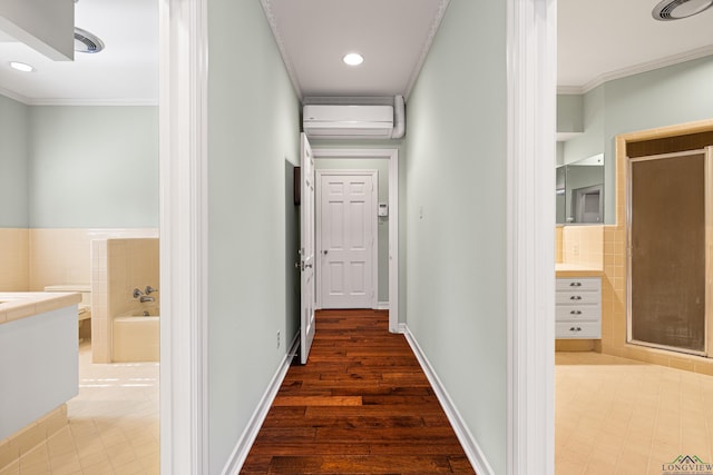 hallway featuring hardwood / wood-style flooring, ornamental molding, and an AC wall unit