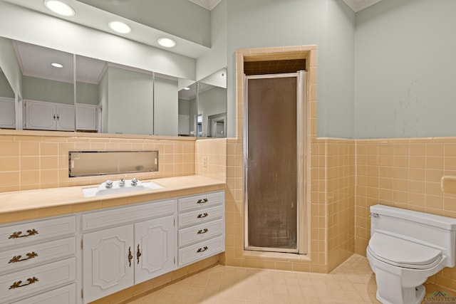 bathroom featuring tile walls, vanity, crown molding, and walk in shower