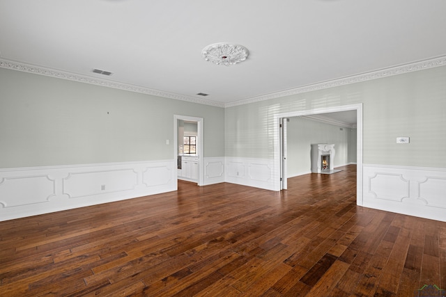 empty room with dark wood-type flooring and crown molding