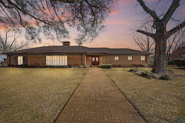 ranch-style house featuring a yard