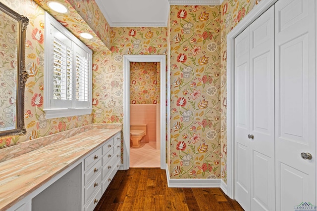 bathroom with vanity, hardwood / wood-style floors, crown molding, and toilet