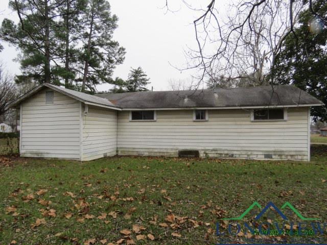 back of house with a lawn