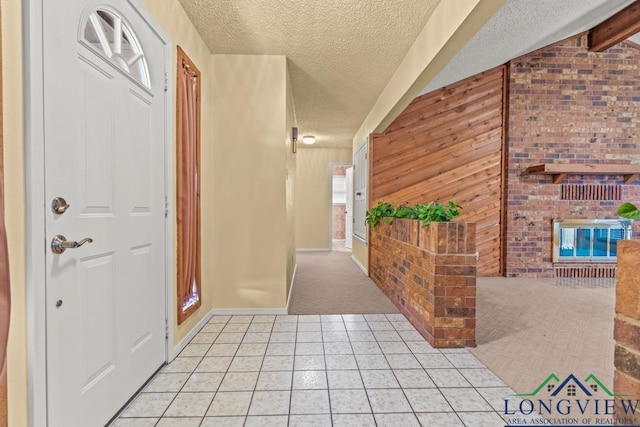 tiled foyer featuring a textured ceiling