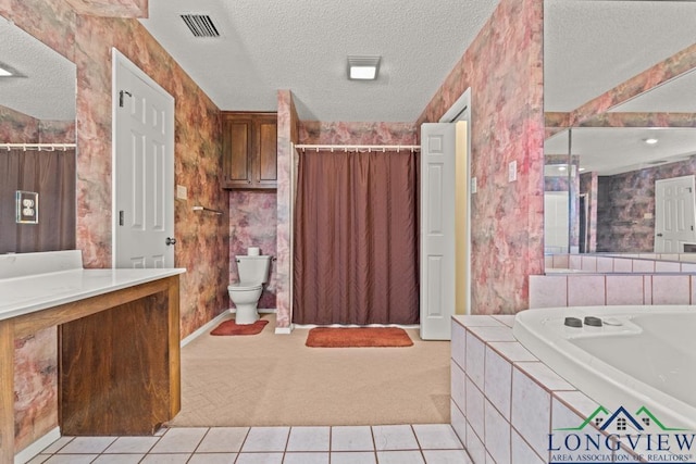 bathroom featuring tile patterned flooring, a relaxing tiled tub, toilet, and a textured ceiling