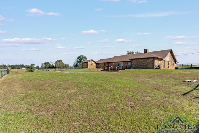 view of yard with a rural view