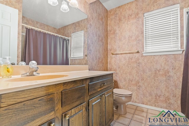 bathroom featuring tile patterned flooring, vanity, and toilet