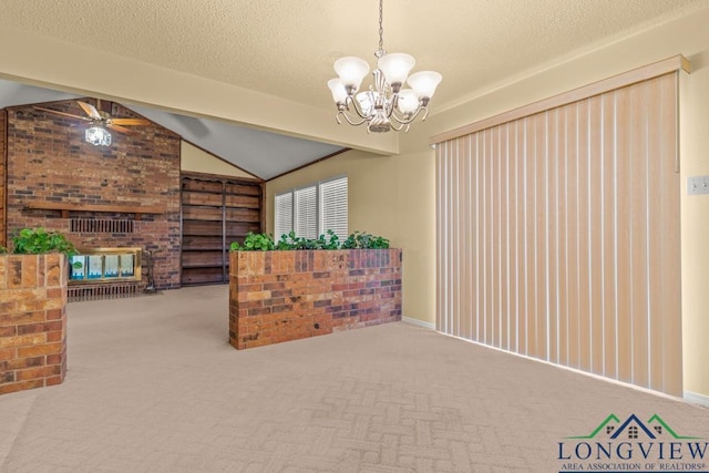 carpeted living room featuring a textured ceiling, vaulted ceiling with beams, ceiling fan with notable chandelier, and a brick fireplace