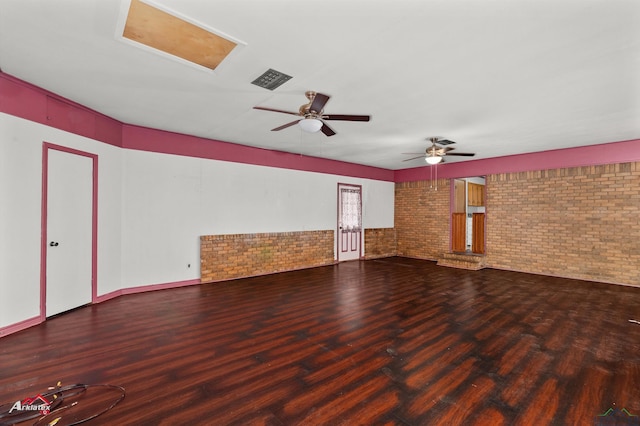 1320 Pinehill Dr, Jefferson, TX 75657 - unfurnished room with brick wall, wood finished floors, and ceiling fan