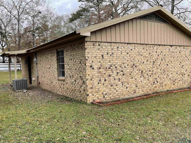 view of side of home featuring a yard and cooling unit