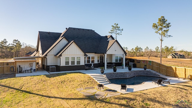 rear view of property with a fenced in pool, a patio area, a yard, and cooling unit