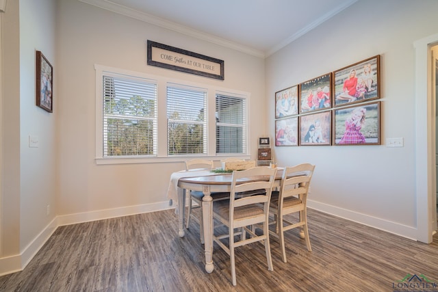 dining space with dark hardwood / wood-style flooring and ornamental molding