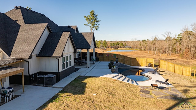 exterior space featuring a patio area, central air condition unit, and a fenced in pool