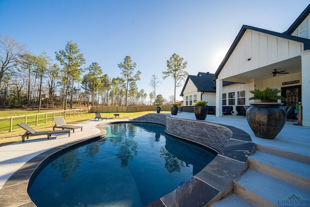 view of pool featuring a lawn, ceiling fan, and a patio