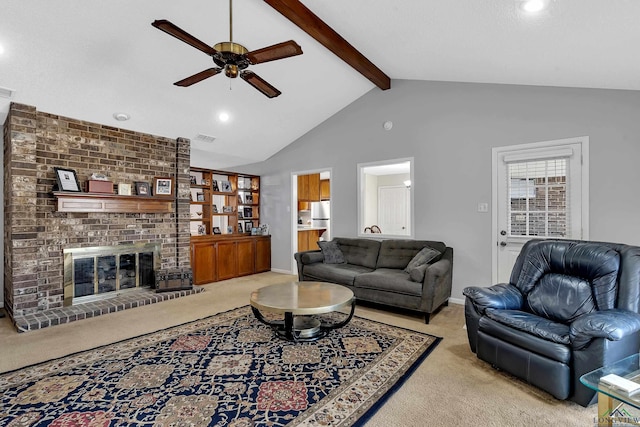 carpeted living area with visible vents, a ceiling fan, baseboards, a brick fireplace, and beam ceiling