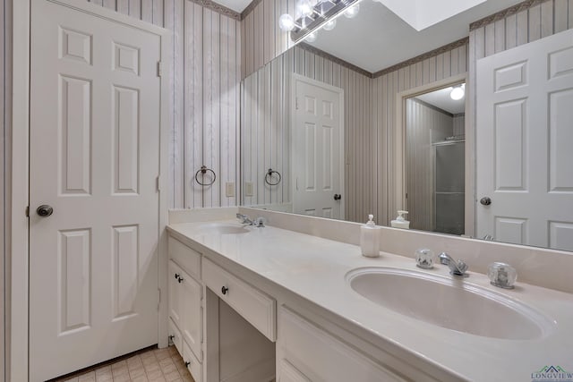 full bath with wallpapered walls, a skylight, a sink, and a shower with shower door